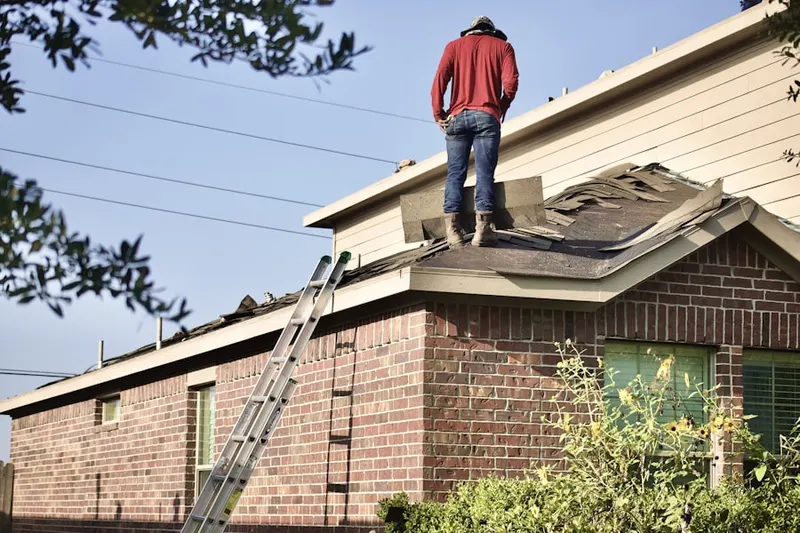 Professional roofer working on a residential roof in Ithaca